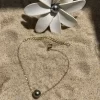 Bracelet chaine fine en or avec perle de Tahiti sur sable